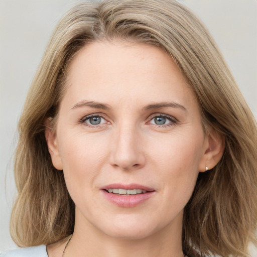 Joyful white young-adult female with medium  brown hair and blue eyes