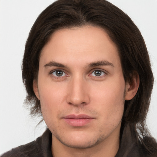 Neutral white young-adult male with long  brown hair and brown eyes