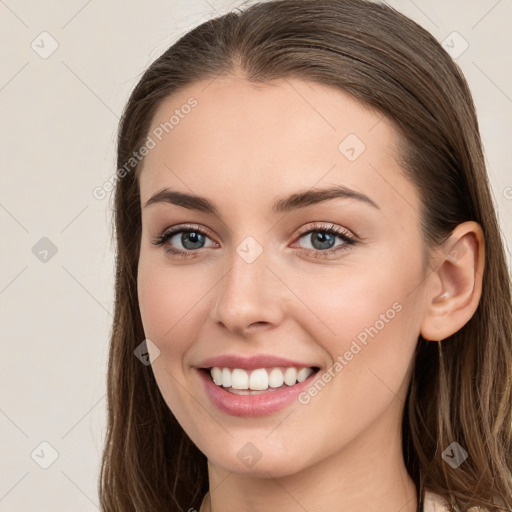 Joyful white young-adult female with long  brown hair and grey eyes