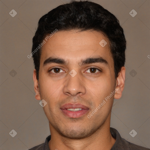 Joyful white young-adult male with short  black hair and brown eyes