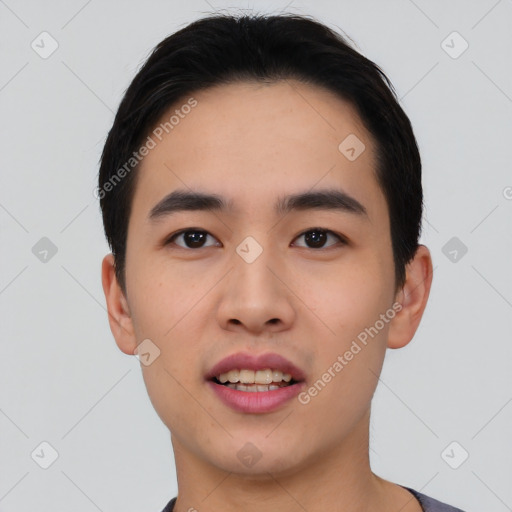 Joyful asian young-adult male with short  black hair and brown eyes