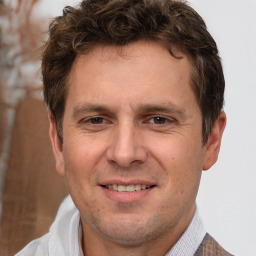 Joyful white adult male with short  brown hair and brown eyes