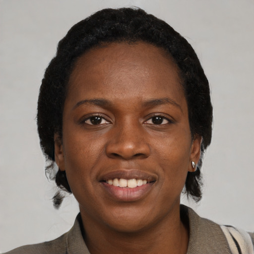 Joyful black young-adult female with medium  black hair and brown eyes