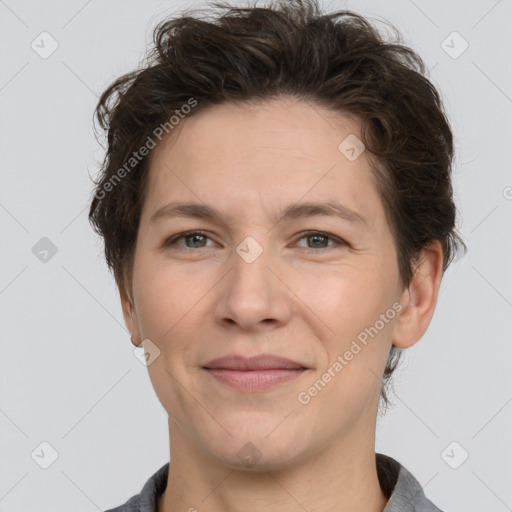 Joyful white adult female with short  brown hair and grey eyes