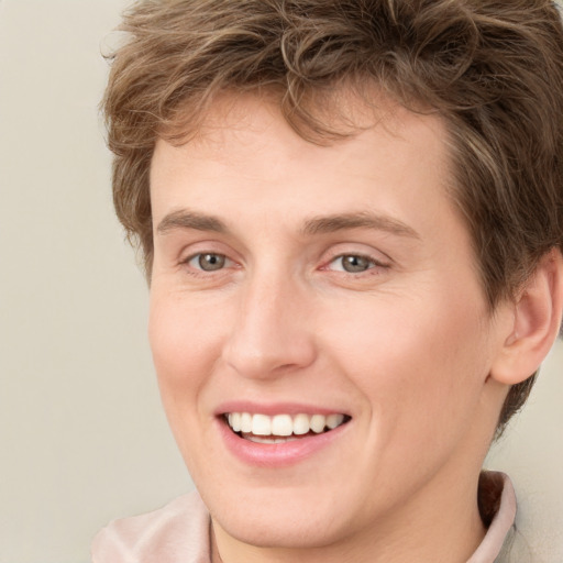 Joyful white young-adult female with short  brown hair and green eyes