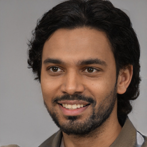 Joyful latino young-adult male with short  brown hair and brown eyes