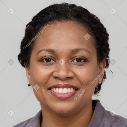 Joyful black adult female with short  brown hair and brown eyes