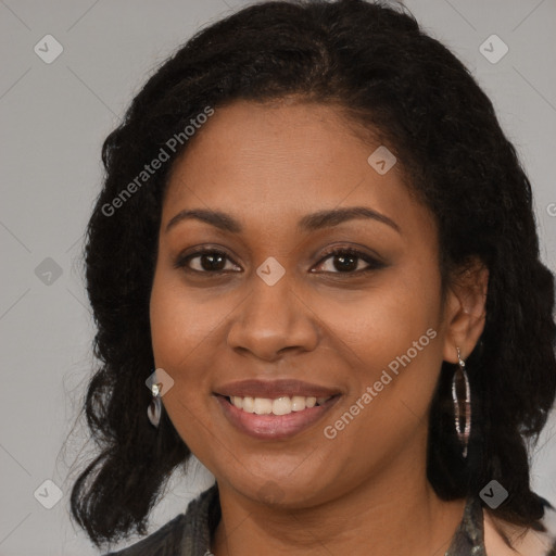 Joyful black young-adult female with long  brown hair and brown eyes