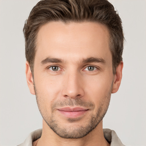 Joyful white young-adult male with short  brown hair and brown eyes