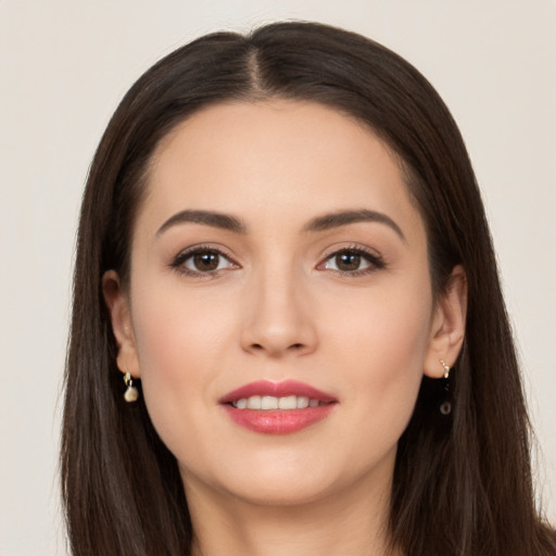 Joyful white young-adult female with long  brown hair and brown eyes