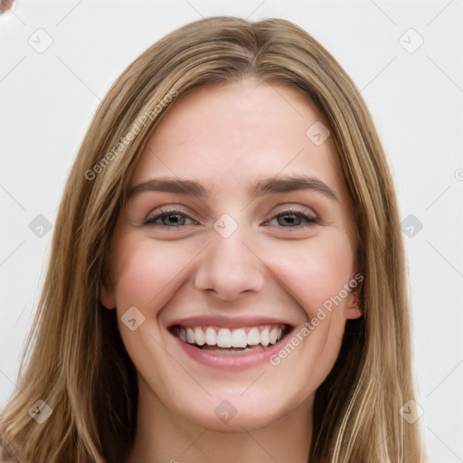 Joyful white young-adult female with long  brown hair and green eyes