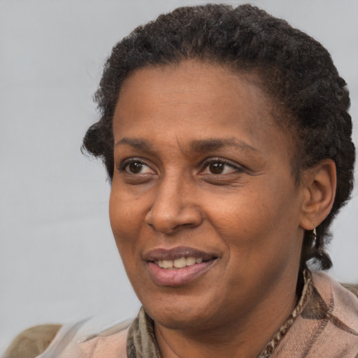 Joyful latino adult female with short  brown hair and brown eyes