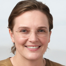 Joyful white young-adult female with medium  brown hair and blue eyes