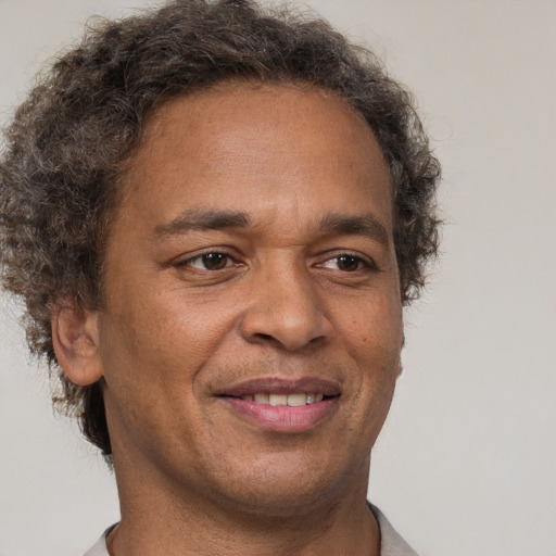 Joyful latino adult male with short  brown hair and brown eyes