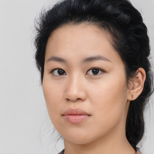 Joyful asian young-adult female with long  brown hair and brown eyes