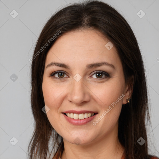 Joyful white young-adult female with long  brown hair and brown eyes