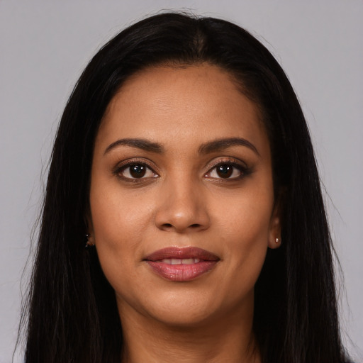 Joyful latino young-adult female with long  brown hair and brown eyes