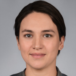 Joyful white young-adult female with medium  brown hair and brown eyes