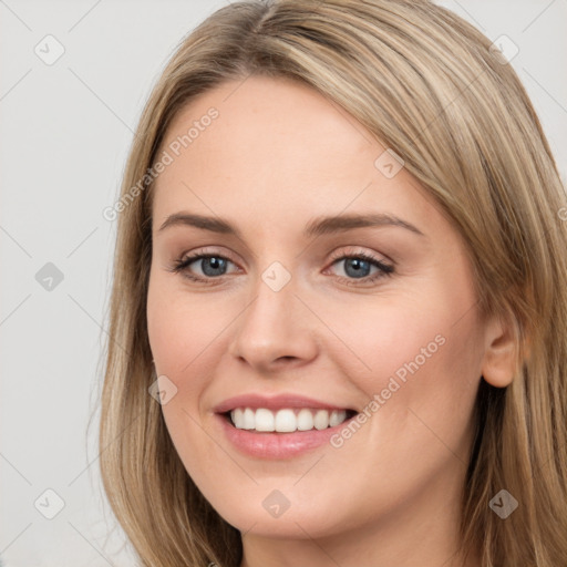 Joyful white young-adult female with long  brown hair and grey eyes