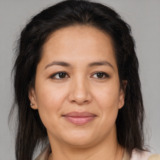 Joyful latino adult female with medium  brown hair and brown eyes