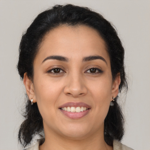 Joyful latino young-adult female with medium  black hair and brown eyes