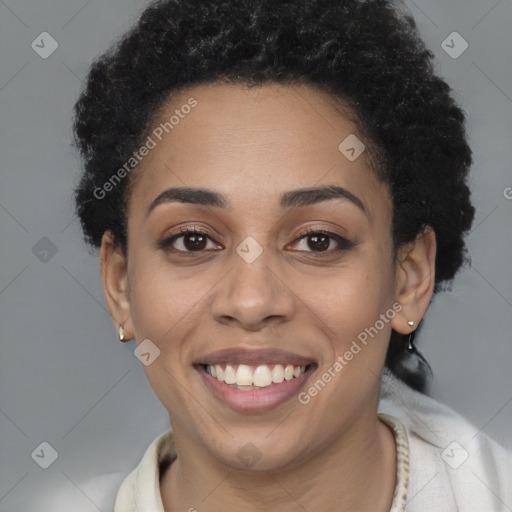 Joyful black young-adult female with short  black hair and brown eyes