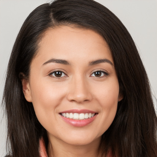 Joyful white young-adult female with long  brown hair and brown eyes