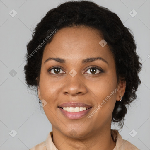 Joyful black adult female with medium  brown hair and brown eyes