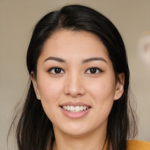 Joyful asian young-adult female with long  brown hair and brown eyes