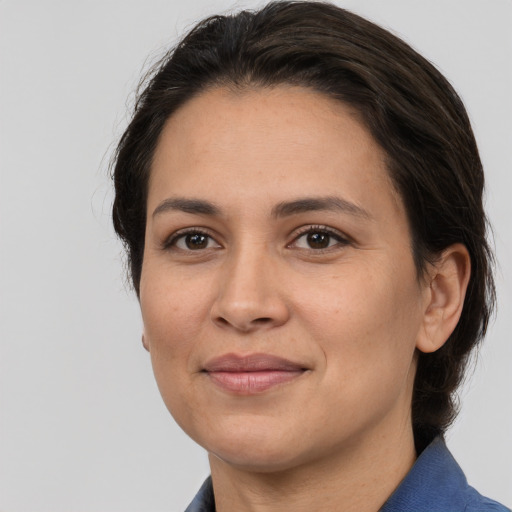 Joyful white adult female with medium  brown hair and brown eyes