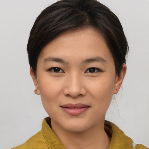 Joyful asian young-adult female with short  brown hair and brown eyes