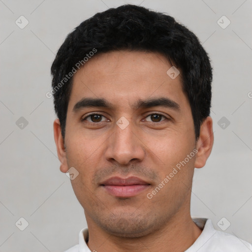 Joyful latino young-adult male with short  black hair and brown eyes