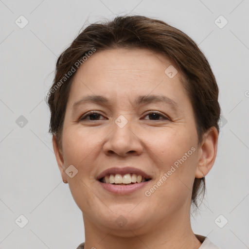 Joyful white adult female with short  brown hair and brown eyes