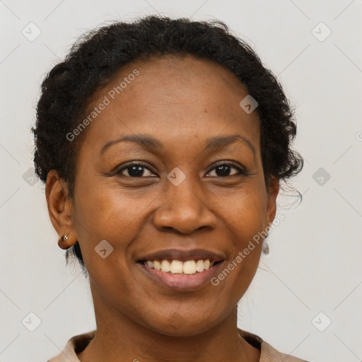 Joyful black adult female with short  brown hair and brown eyes