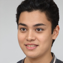 Joyful latino young-adult male with short  brown hair and brown eyes