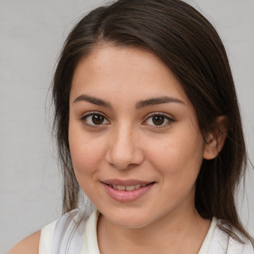 Joyful white young-adult female with long  brown hair and brown eyes