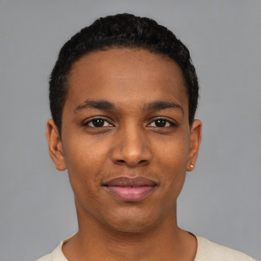 Joyful black young-adult male with short  black hair and brown eyes