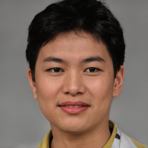 Joyful asian young-adult male with short  brown hair and brown eyes