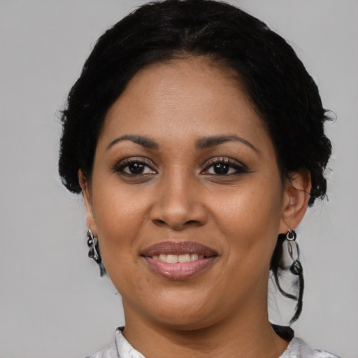 Joyful latino young-adult female with medium  black hair and brown eyes