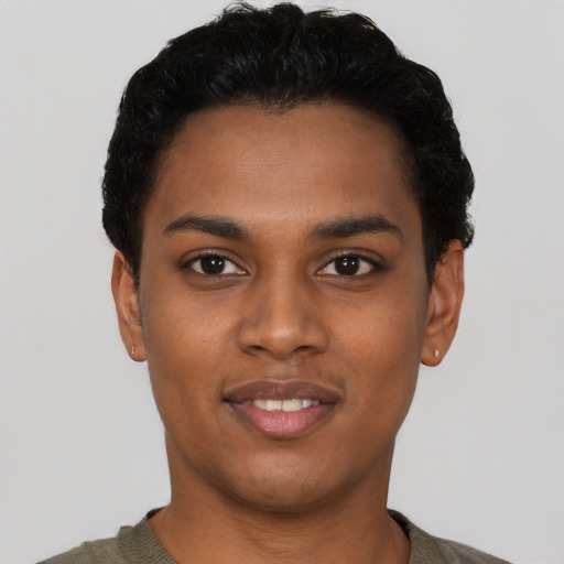 Joyful black young-adult female with short  black hair and brown eyes