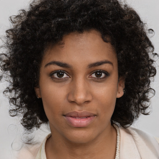 Neutral black young-adult female with medium  brown hair and brown eyes