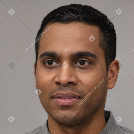 Joyful latino young-adult male with short  black hair and brown eyes