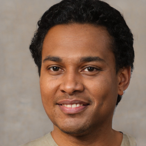 Joyful latino young-adult male with short  black hair and brown eyes