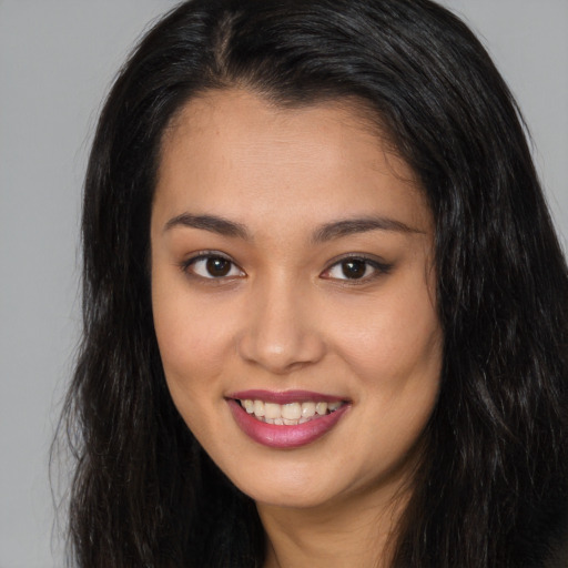 Joyful asian young-adult female with long  brown hair and brown eyes