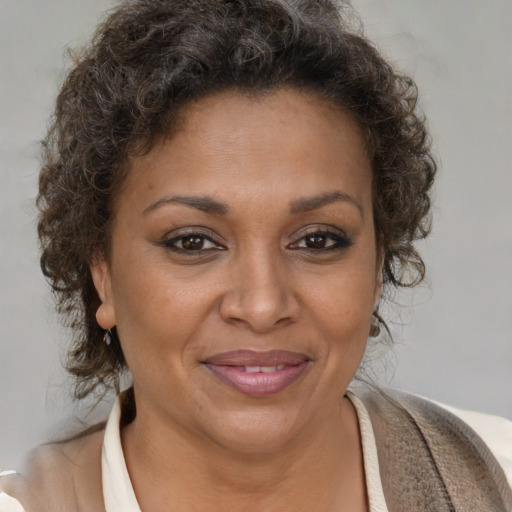Joyful black adult female with short  brown hair and brown eyes