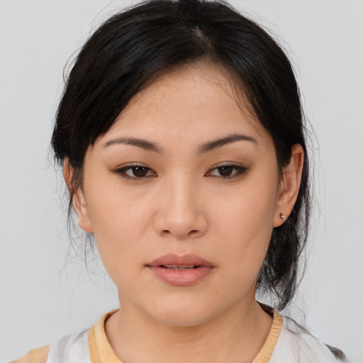 Joyful asian young-adult female with medium  brown hair and brown eyes