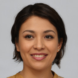 Joyful asian young-adult female with medium  brown hair and brown eyes