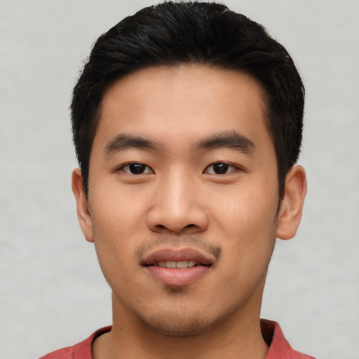 Joyful asian young-adult male with short  black hair and brown eyes