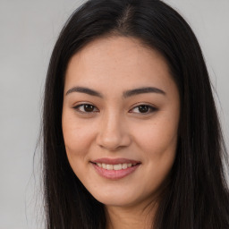 Joyful asian young-adult female with long  brown hair and brown eyes