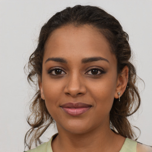 Joyful latino young-adult female with medium  brown hair and brown eyes